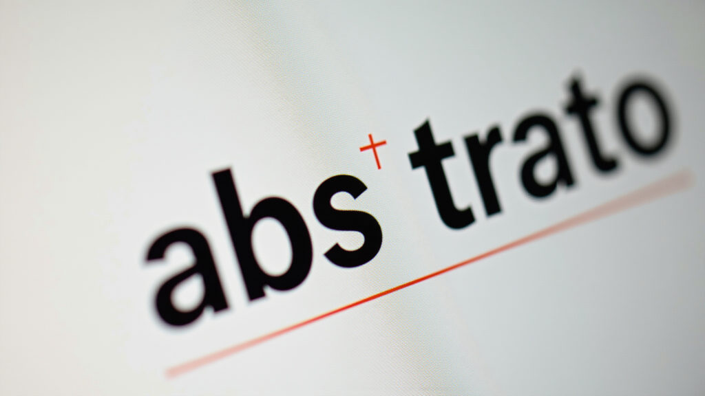 Close-up of the word 'abstracto' with a line separating 'abs' and 'tra'. Natural lighting, sharp Palavra 'abstrato' com a separação silábica 'abs-tra'.